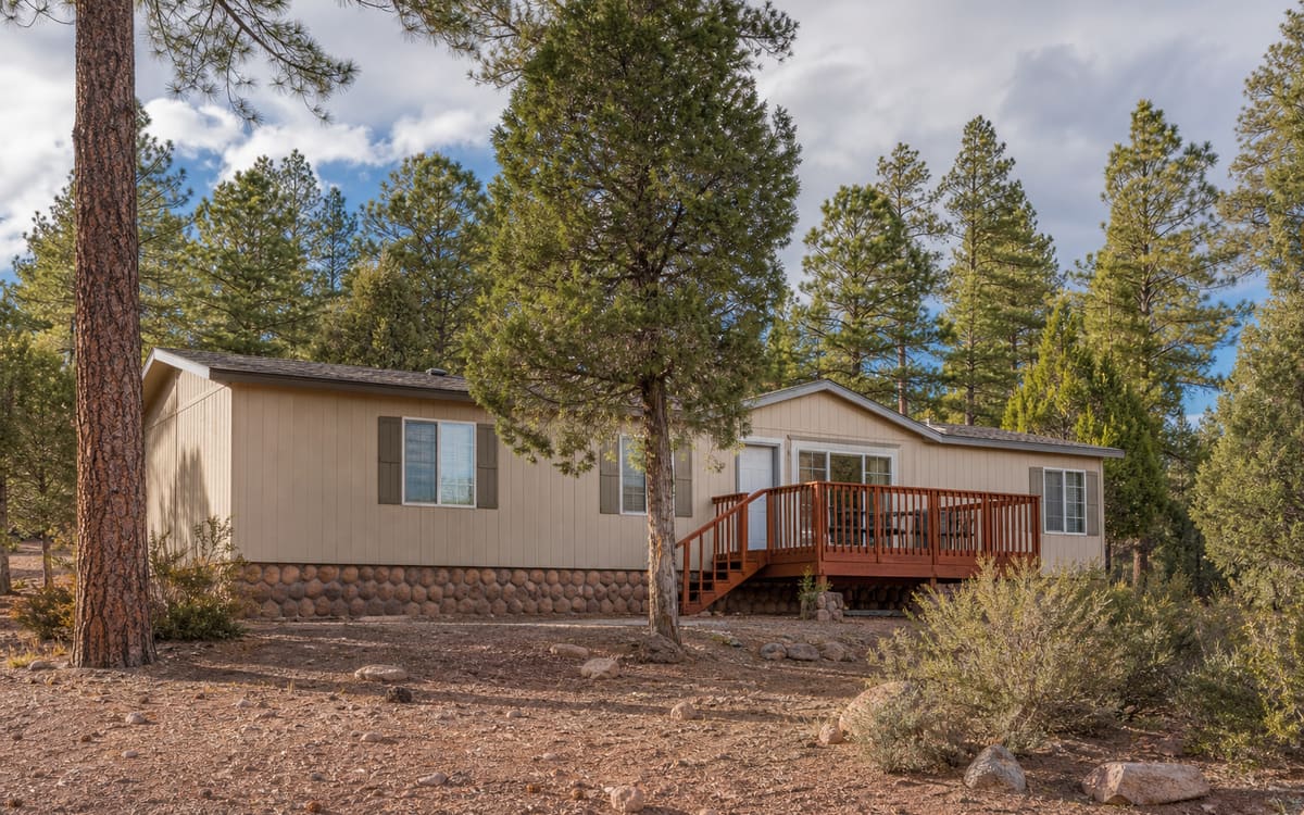 A manufactured home in Arizona's White Mountains pine and juniper forest