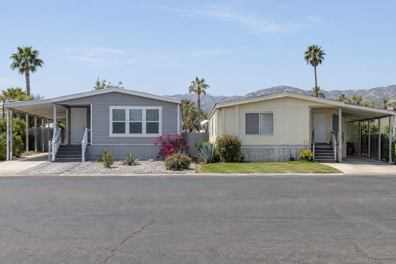 Two double-wide manufactured homes of similar size side by side on a community street, one with newer siding and windows and one in original condition